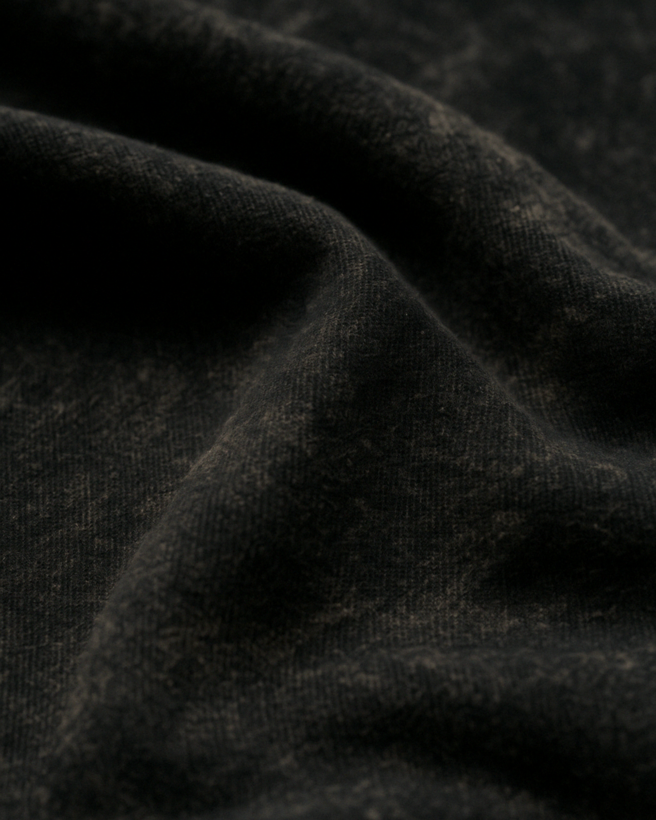 Closeup of Black acid wash fabric – soft texture, premium cotton knit