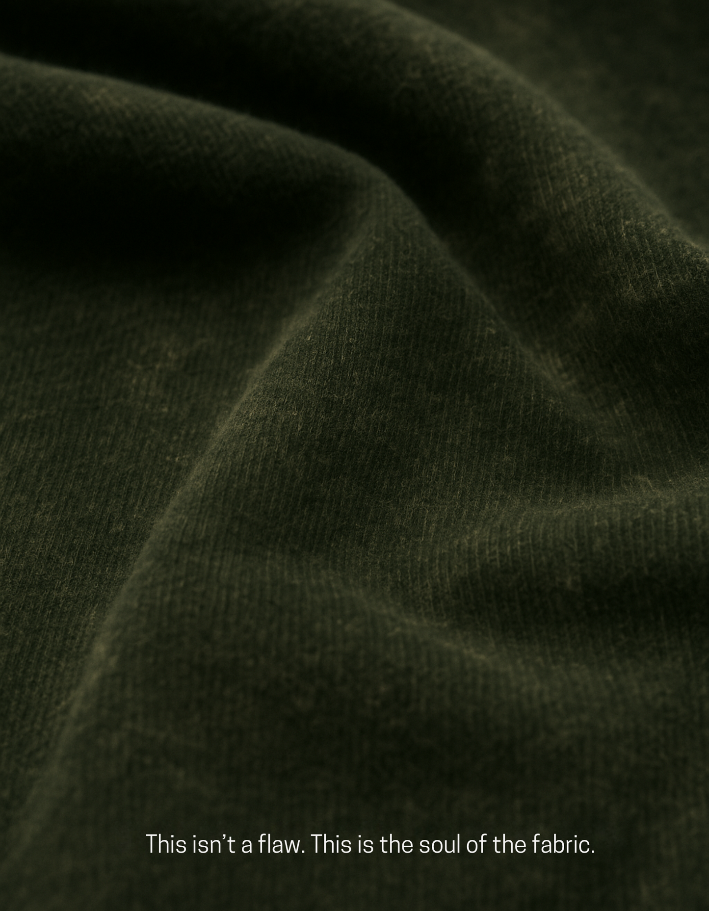 Close-up of olive green acid-washed cotton fabric from Chakra Backflow Tee