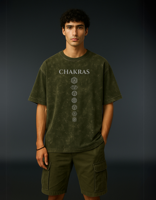 Front view of Chakra Backflow Tee in olive green with vertical chakra sequence print.