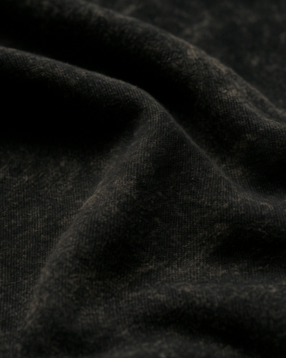 Closeup of Black acid wash fabric – soft texture, premium cotton knit