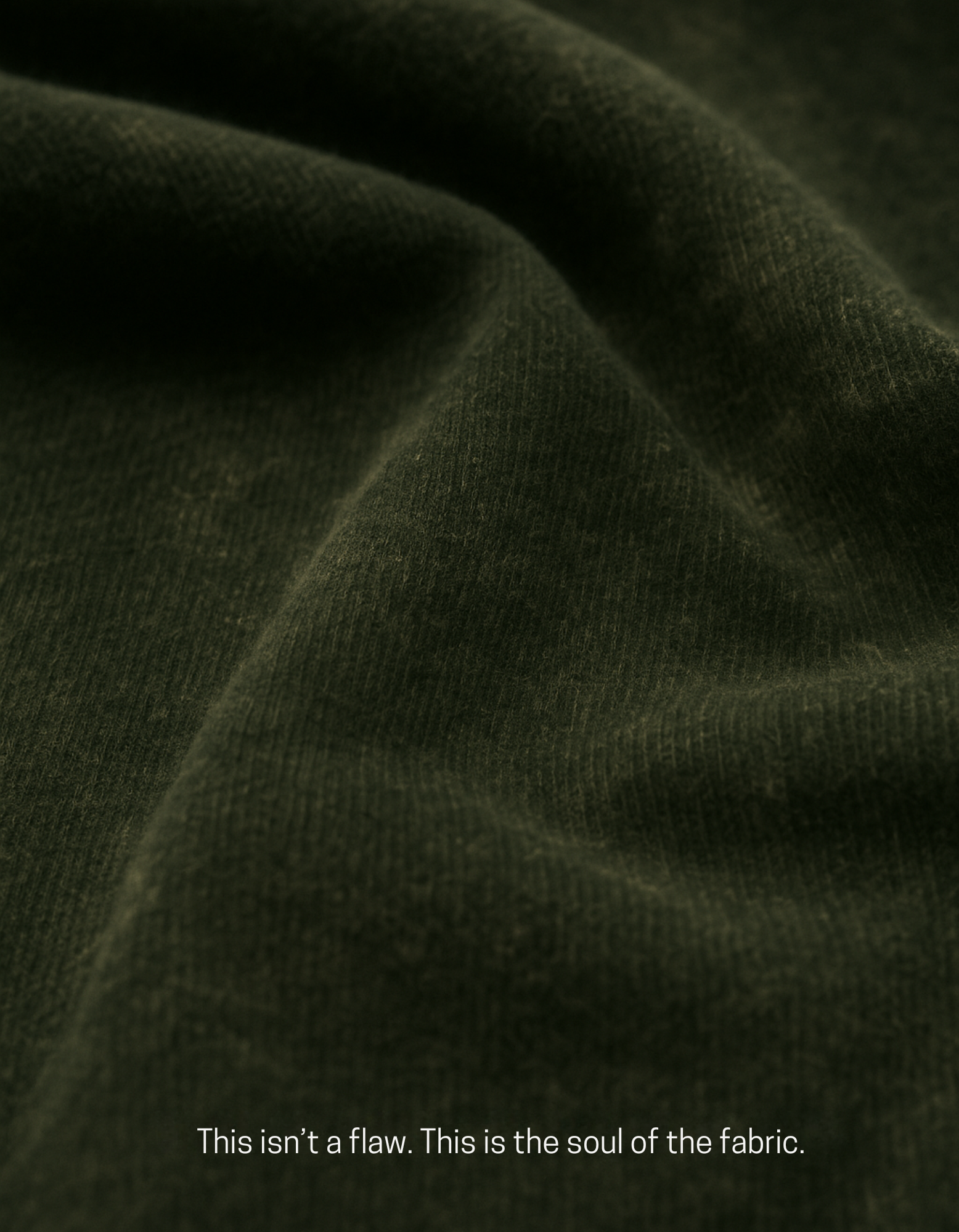 Close-up of olive green acid-washed cotton fabric from Chakra Backflow Tee