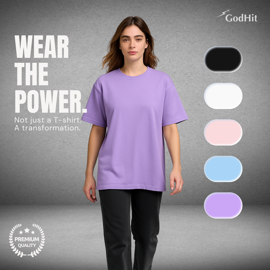 Confident woman wearing GodHit lavender oversized T-shirt, walking forward with “Wear the Power – Not just a T-shirt. A transformation.” tagline and color swatches on side.