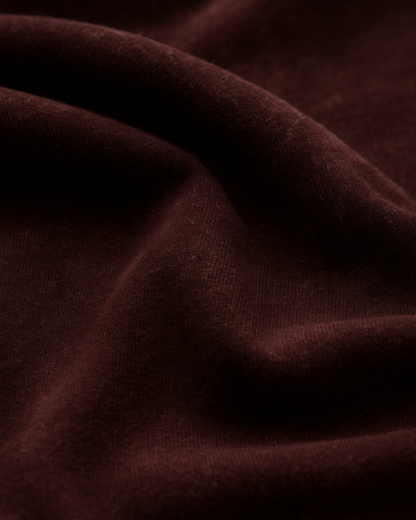 Closeup of maroon acid wash fabric – soft texture, premium cotton knit
